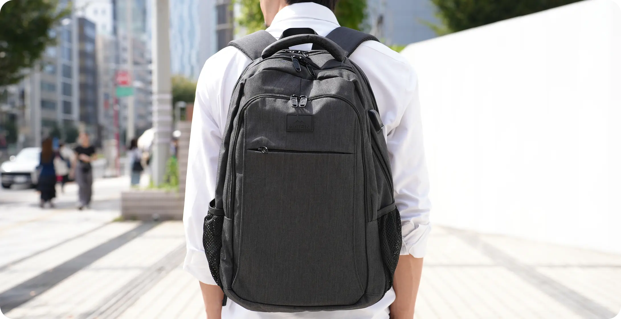 バックパックを背負って歩くビジネスパーソン